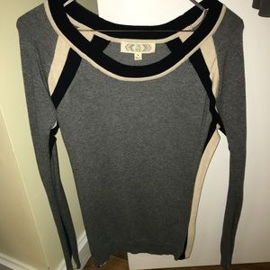 Grey sweater with black and cream striped sleeves